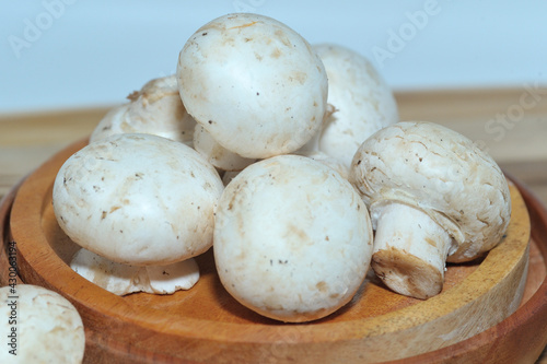 Mushrooms on a wooden chopping board on a white background