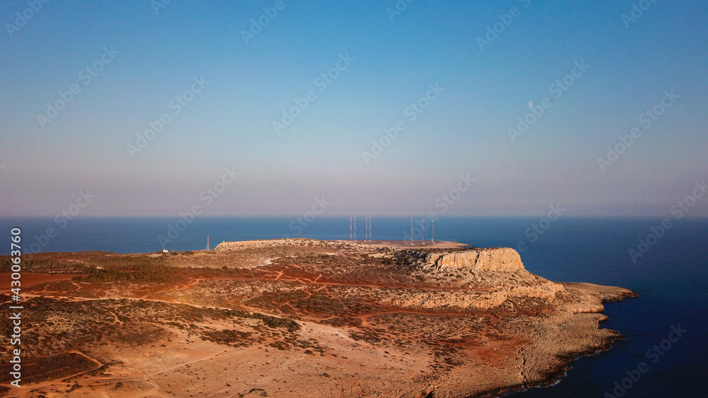 Aerial view of Cape Greco overlooking the mountain, Mediterranean sea and desert area at sunset, Cyprus photo by drone