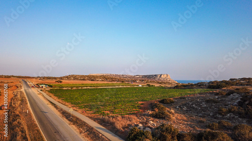 Aerial view of Cape Greco overlooking the mountain, Mediterranean sea and watermelon field, Cyprus photo by drone