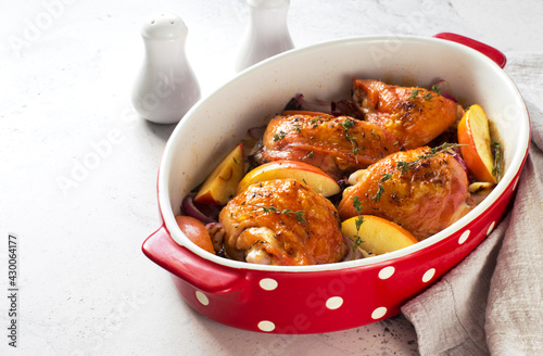 Oven baked chicken thighs in a cooking tray close up