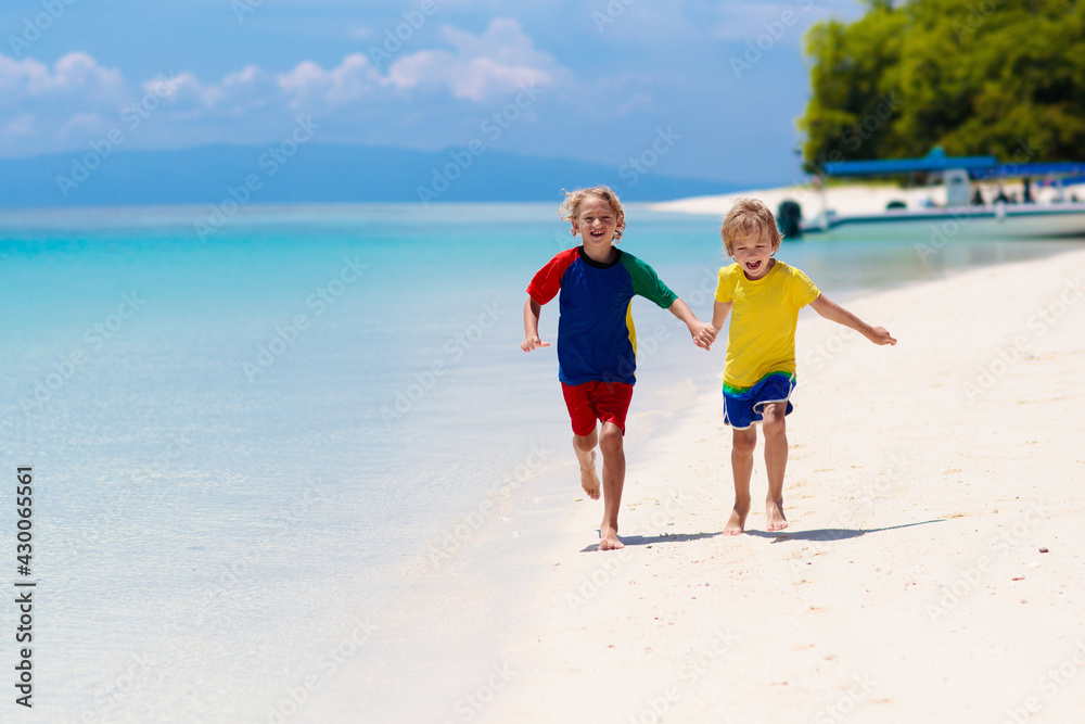 Kids playing on beach. Children play at sea.