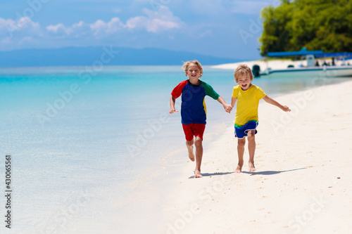 Kids playing on beach. Children play at sea.