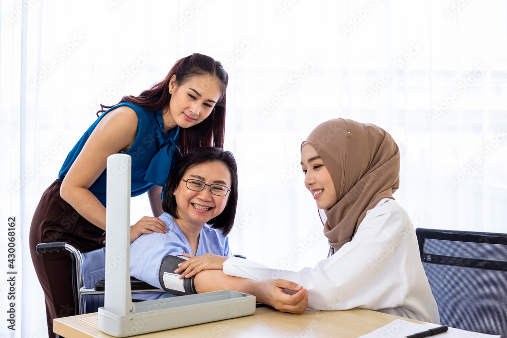 Senior woman patient with relative daughter having consultation with doctor in office clinic hospital, measure blood pressure with sphygmomanometer Senior woman patient with relative daughter having consultation with doctor in office clinic hospital, measure blood pressure with sphygmomanometer