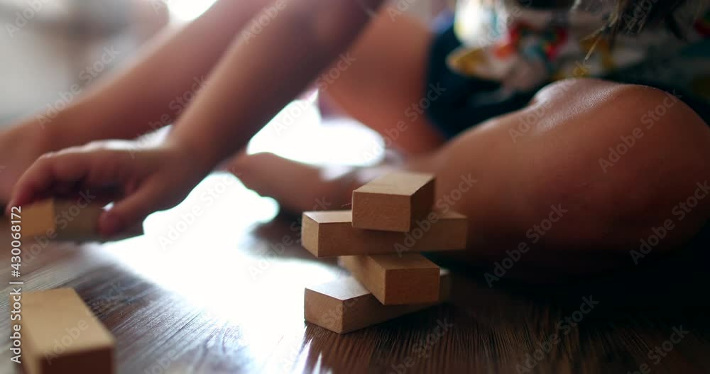 Child playing with wooden building blocks