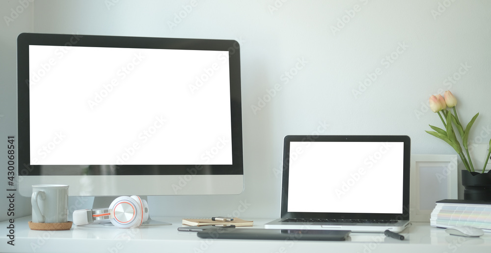 Modern workspace with computer with blank screen and equipment on white table.Blank screen for your information.