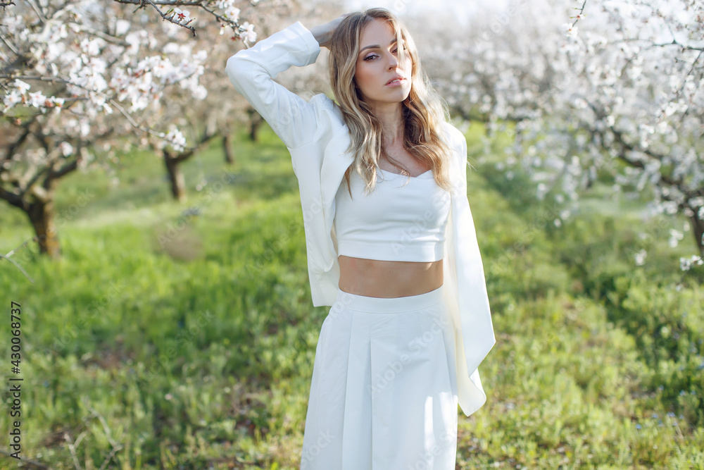 Woman in a blooming garden. Beautiful woman in nature. High quality photo. Woman in a blooming garden. Beautiful woman in nature. High quality photo.