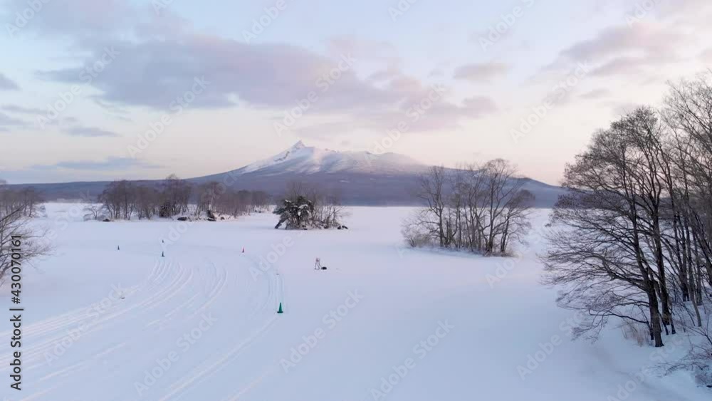 Slow aerial dolly forward over beautiful natural landscape park in winter