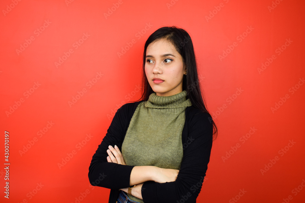 Portrait of Young beautiful asian women using black sweater with red isolated background Portrait of Young beautiful asian women using black sweater with red isolated background