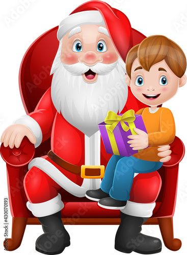 Santa Claus sitting in chair with a little cute boy