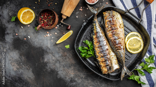 baked mackerel fish in a pan with lemon herbs and spices, banner, menu recipe place for text, top view