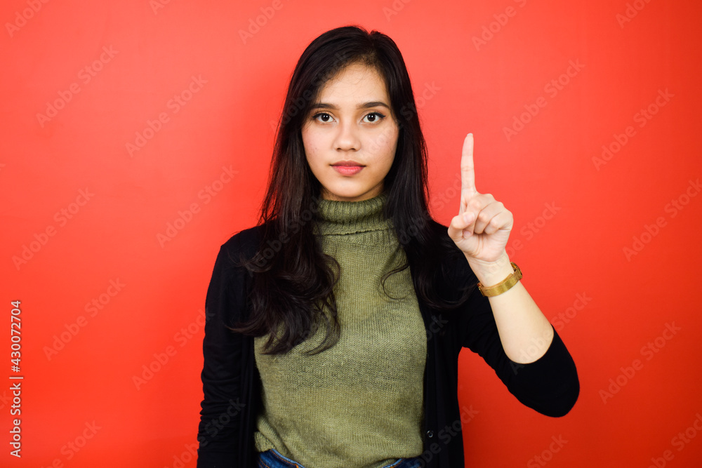 Young beautiful asian women using black sweater with red isolated background Young beautiful asian women using black sweater with red isolated background