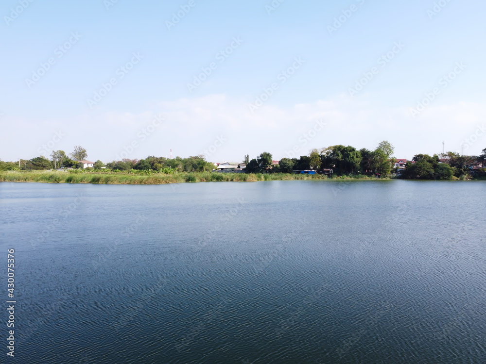 Big lake in countryside near village.