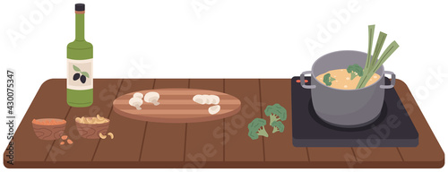 Process of cooking vegetarian food. Proper nutrition, healthy lifestyle and vegetarianism concept. Ingredients and cooking utensils for making soup or porridge. Natural ingredients for dish in pan