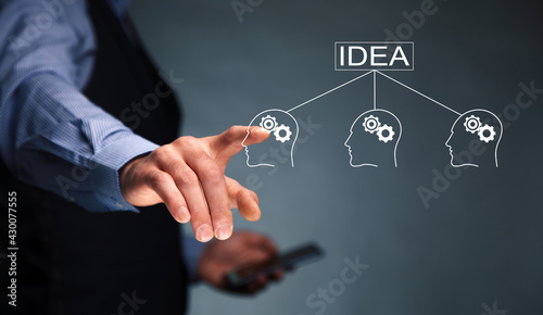 man holding phone with idea and gears icon