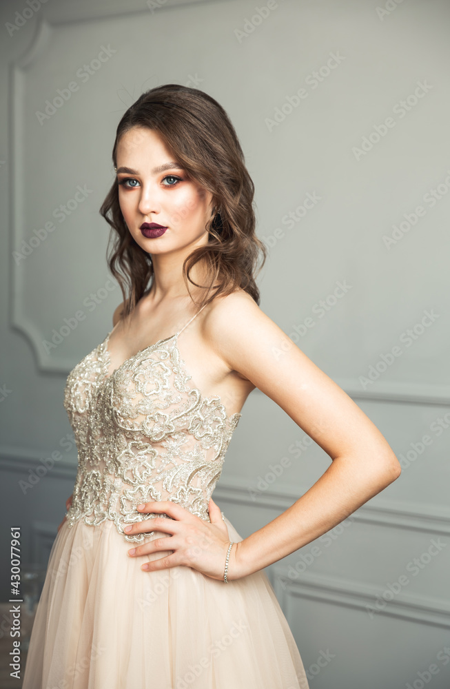 Fashion model bride with flowing blonde hair and makeup. Beautiful lady wearing white dress. Tender portrait of a adorable woman. Wedding dress on fashion model. Delicate portrait of young model girl Fashion model bride with flowing blonde hair and makeup. Beautiful lady wearing white dress. Tender portrait of a adorable woman. Wedding dress on fashion model. Delicate portrait of young model girl