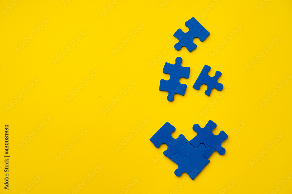 Blue puzzle pieces on paper background top view Blue puzzle pieces on paper background top view