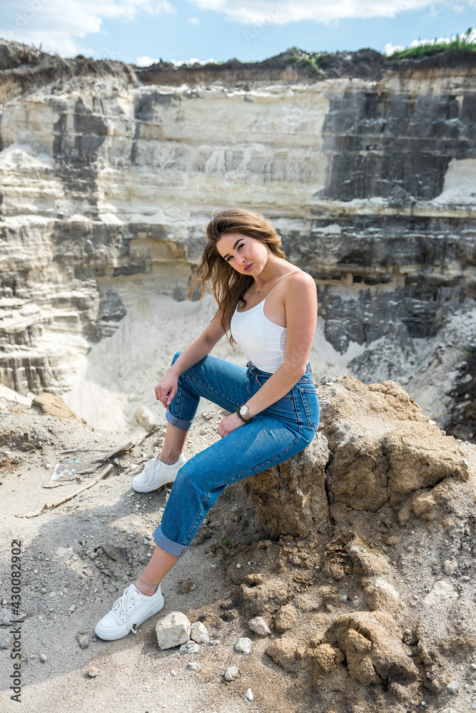 sexy beautiful young woman poses casual clothes on sand quarry sexy beautiful young woman poses casual clothes on sand quarry