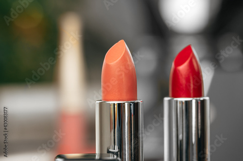 Pink and red lipsticks on vanity table
