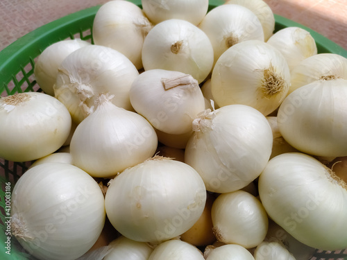 bulk of white onions in the marketplace  closeup