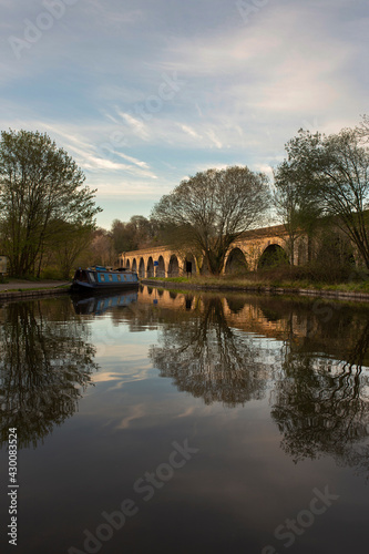 Chirk aqueduct and viaduct on the Llangollen canal, on the border of England and Wales. With a barge narrowboat moored