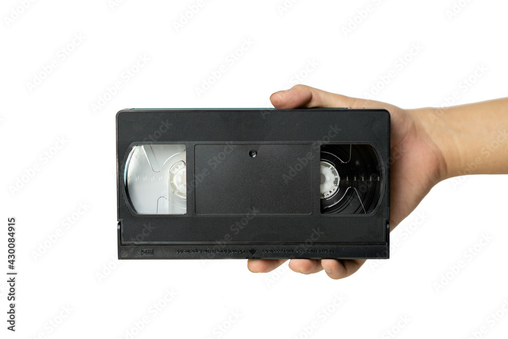 Video tape cassette VHS holding in hand. - obrazy, fototapety, plakaty 
