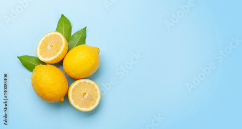 Fresh ripe lemons on blue background