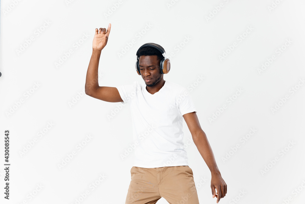 Naklejka premium African American in headphones gesturing with hands music technology fun