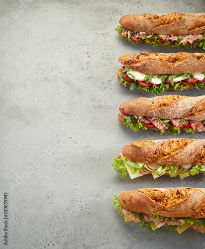 Foto Row of fresh sandwiches on table