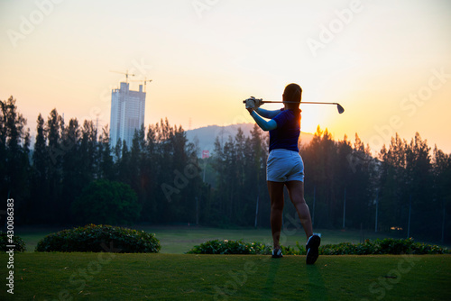 Women golfer Using golf clubs To help twist To warm up body before the play game, with blurred soft nature background,Lifestyle Concept. Sport Concept