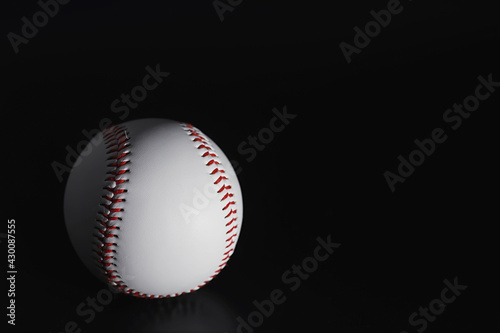 American traditional sports game. Baseball. Concept. Baseball ball and bats on a black table.