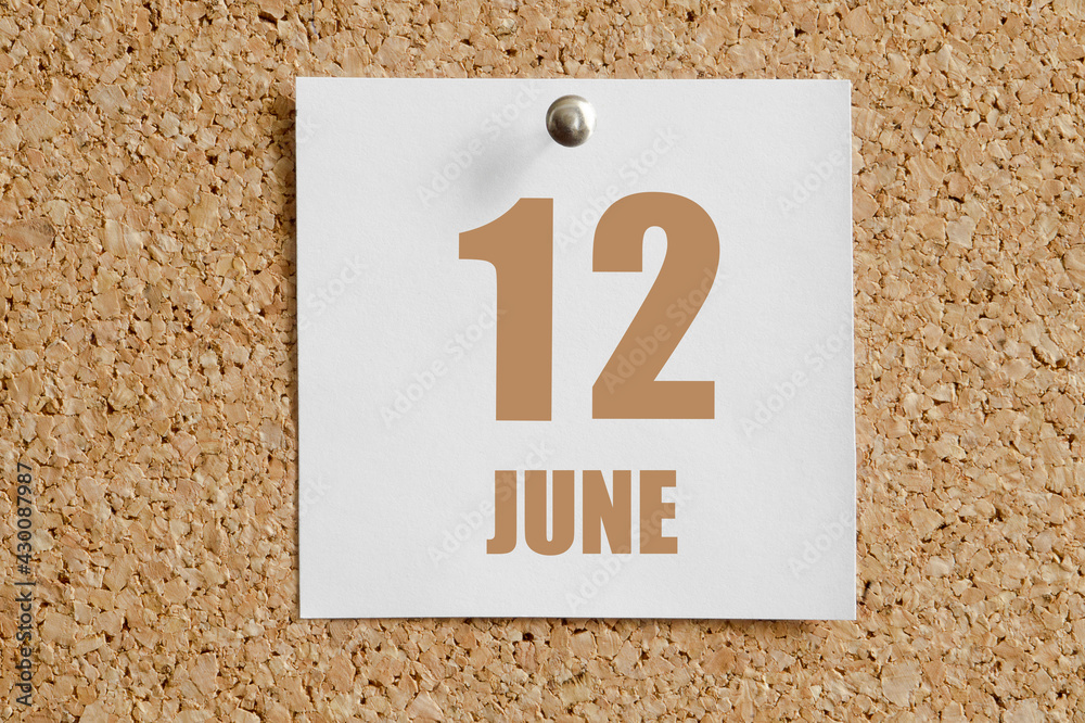 june 12. 12th day of the month, calendar date.White calendar sheet attached to brown cork board.Summer month, day of the year concept june 12. 12th day of the month, calendar date.White calendar sheet attached to brown cork board.Summer month, day of the year concept