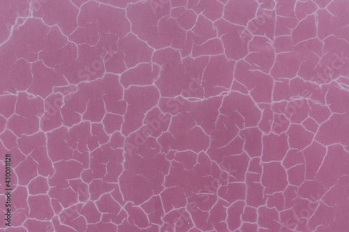 White cracks on the wall. Paint color - Mauve Taupe Hue Red.