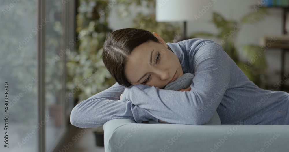 Depressed young woman lying on the couch Depressed young woman lying on the couch