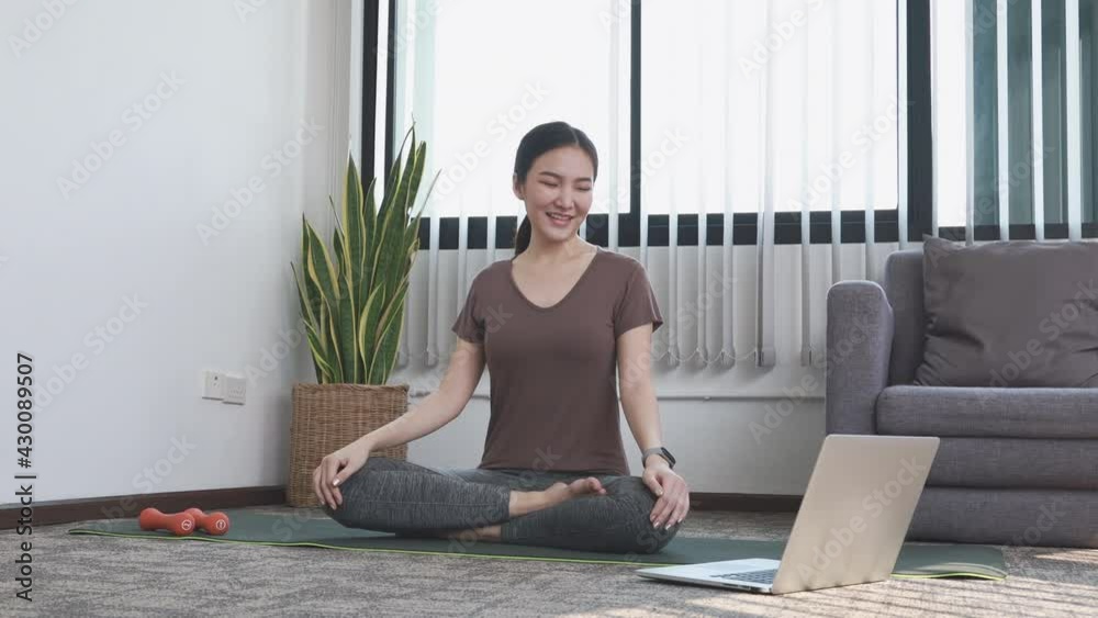 Woman doing yoga in living room, Exercising for health. Woman doing yoga in living room, Exercising for health.