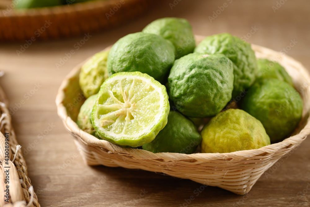Fresh bergamot fruit in a basket on wooden table, Food ingredients and extract used for medicine, tea, perfumes and cosmetics Fresh bergamot fruit in a basket on wooden table, Food ingredients and extract used for medicine, tea, perfumes and cosmetics