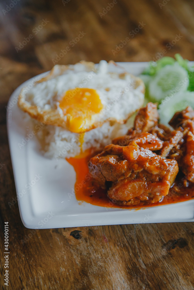 steamed pork and rice with A fried egg on wood table steamed pork and rice with A fried egg on wood table
