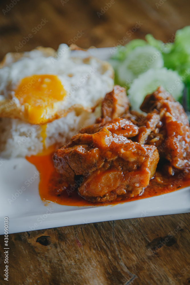 steamed pork and rice with A fried egg on wood table steamed pork and rice with A fried egg on wood table