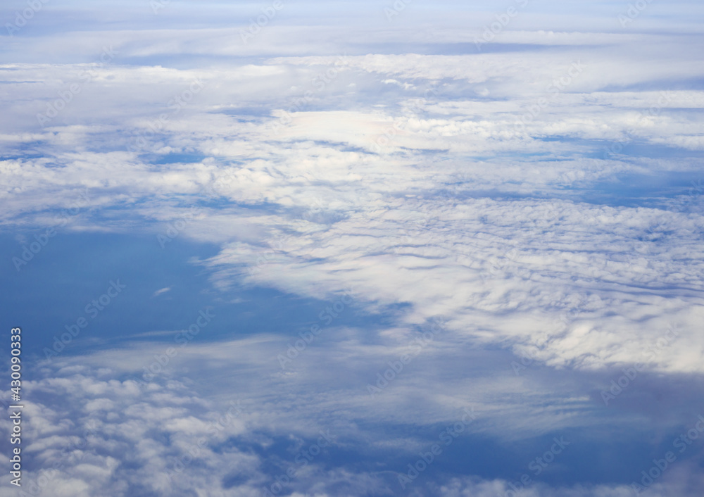 Cloudy blue sky taken from the airplane.