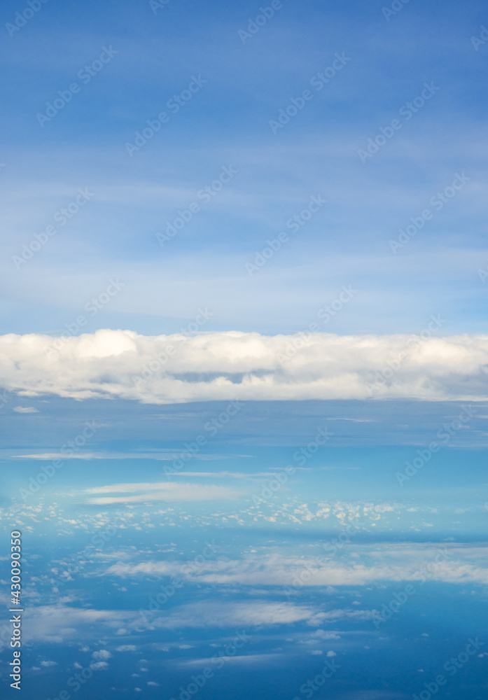 Blue sky and clouds view from airplane window.