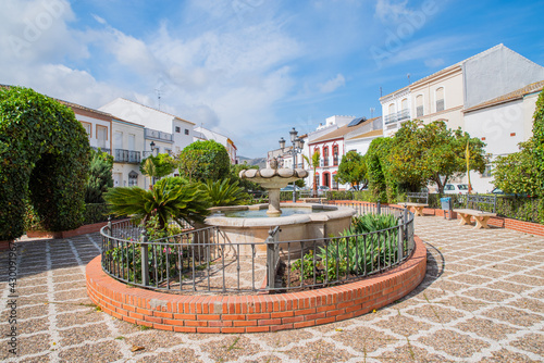 central square with a fountain and a church in a town of Almargen in Malaga Andalusia