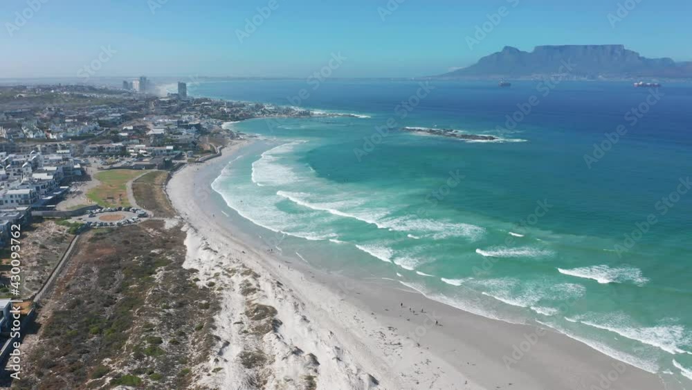 Aerial moving along the shoreline of Big Bay, Cape Town, South Africa. CAPE TOWN, SOUTH AFRICA. Aerial moving along the shoreline of Big Bay, Cape Town, South Africa. CAPE TOWN, SOUTH AFRICA.