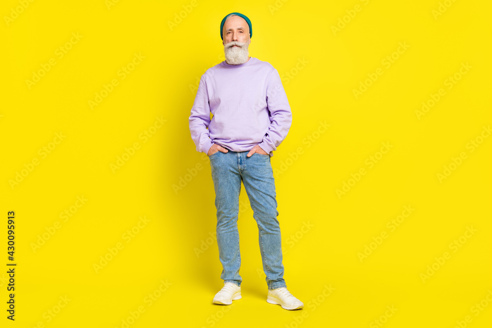 Full length body size photo of serious confident man wearing stylish clothes isolated on bright yellow color background Full length body size photo of serious confident man wearing stylish clothes isolated on bright yellow color background