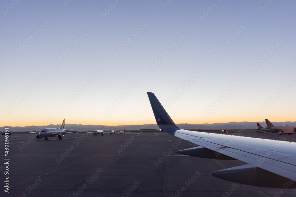 Fototapeta premium Beautiful dawn blue sky over parked planes at the airport