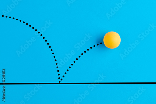 Fotografia Bouncing table tennis ball is on blue background.