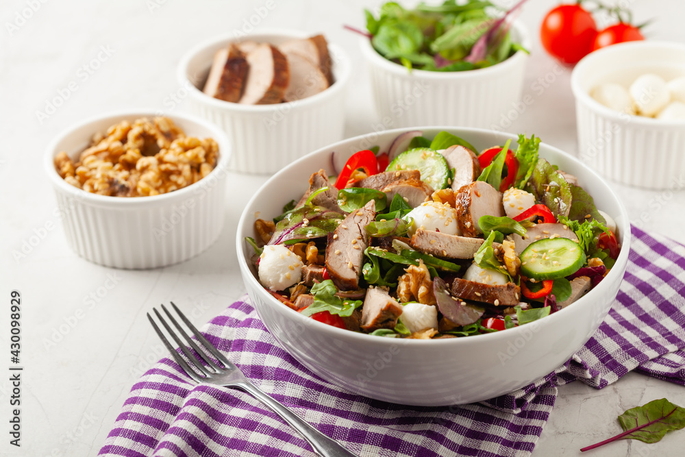 Salad with pork tenderloin, fresh cucumber and mozzarella.