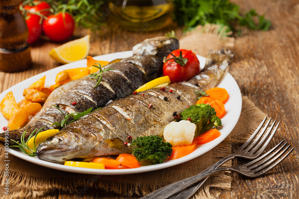 Grilled whole trout. Served with baked potatoes. Grilled whole trout. Served with baked potatoes.