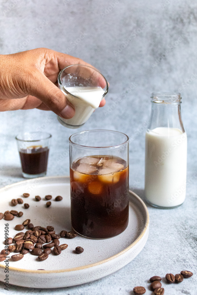 person pouring milk in coffee decoction - morning coffee person pouring milk in coffee decoction - morning coffee