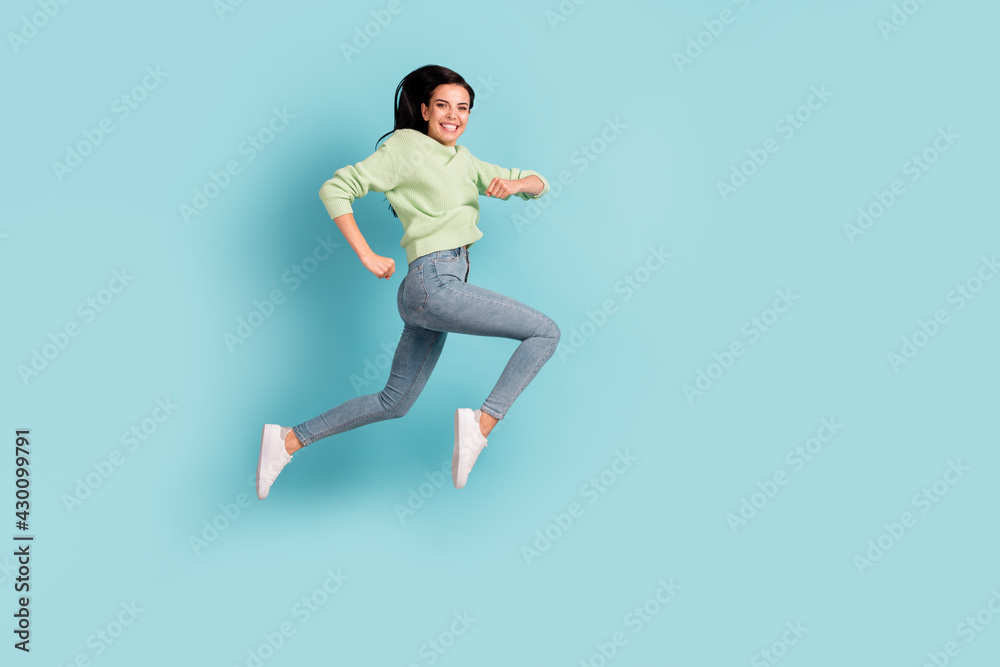 Full length body size profile side view of lovely cheerful girl running having fun isolated over bright blue color background