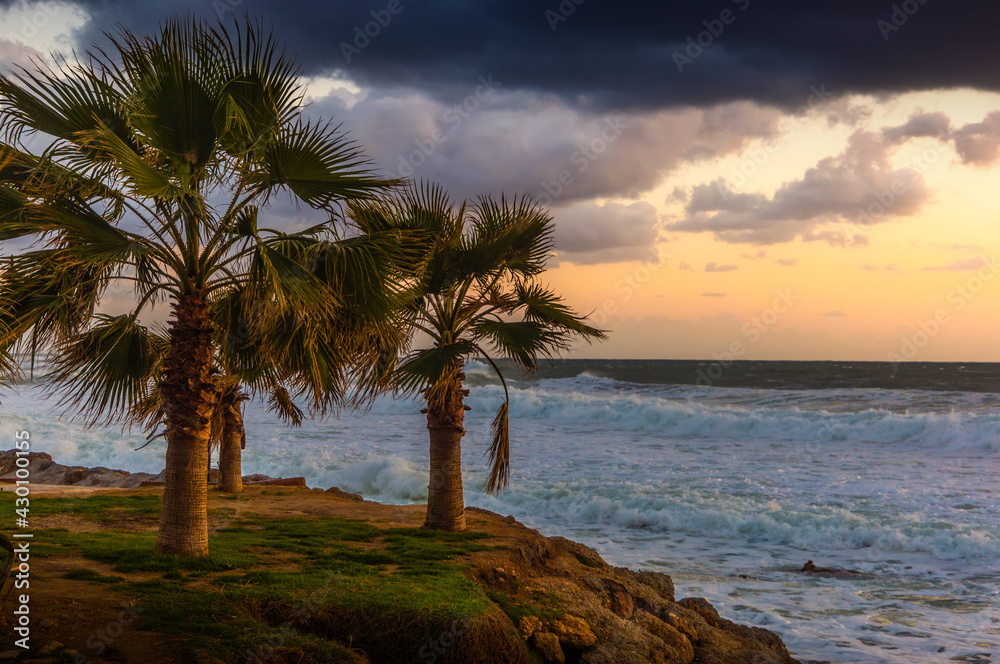 Cloudy sunset in the stormy sea on a tropical island. Cloudy sunset in the stormy sea on a tropical island.