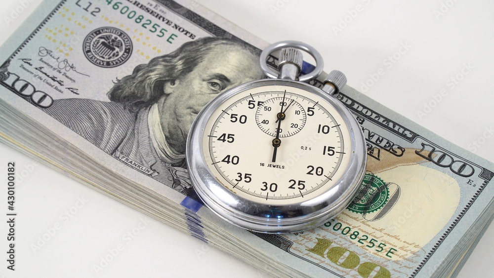 Stopwatch on a bundle of American dollars money. Stopwatch on a bundle of American dollars money.
